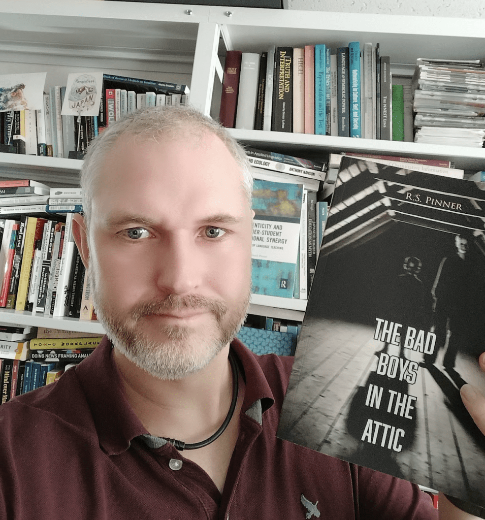 RS Pinner posing with his book a year after publication